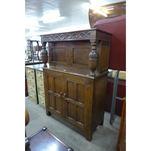 173 - A carved Ipswich oak court cupboard