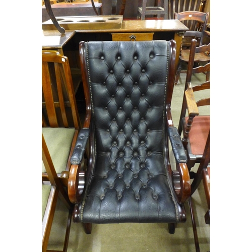 179 - A mahogany and black leather open armchair