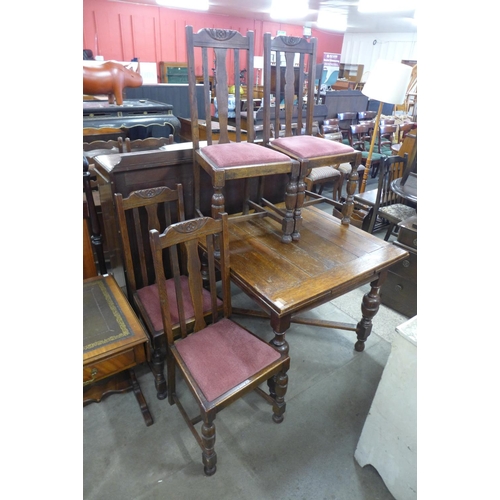 181 - An oak draw-leaf table and four chairs