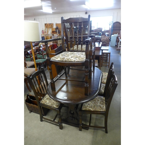 183 - An oak extending dining table, six chairs and a corner cabinet