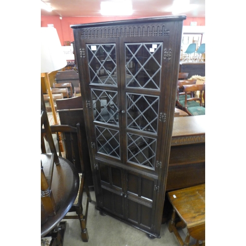 183 - An oak extending dining table, six chairs and a corner cabinet