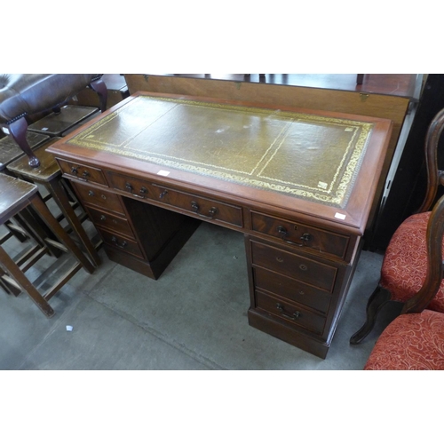 187 - A mahogany and leather topped pedestal desk