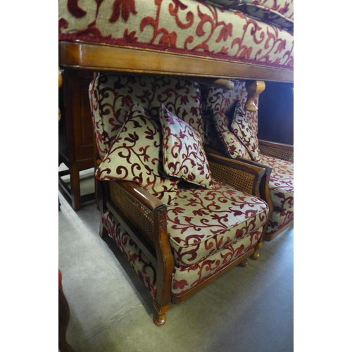 189 - A mahogany bergere settee and pair of armchairs, a/f