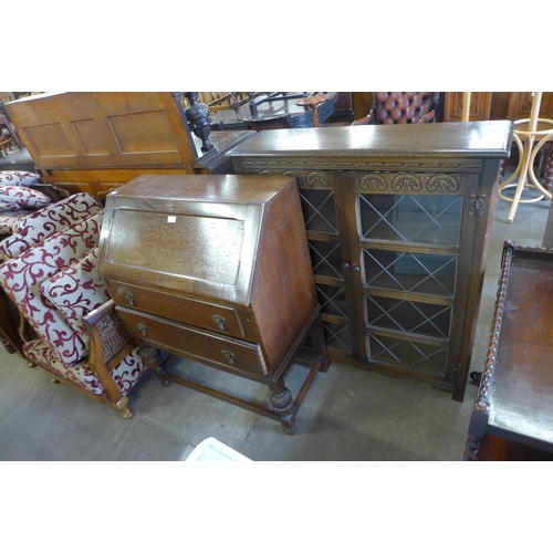 190 - An oak two door bookcase and a bureau