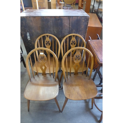 197 - A set of four Ercol Golden Dawn elm and beech fleur de lys chairs