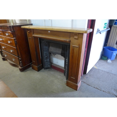 225 - A cast iron fire surround with beech chimney-piece