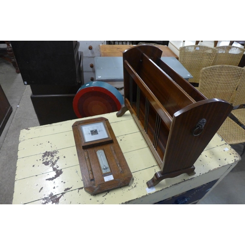 232 - An oak aneroid barometer and a mahogany magazine rack