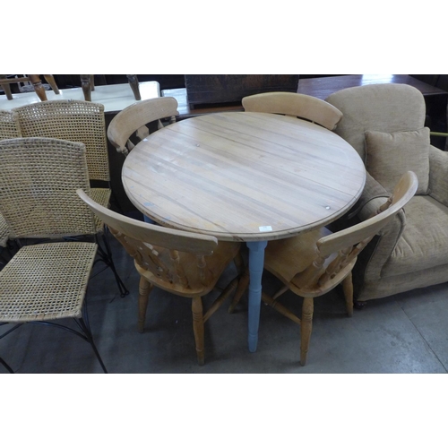 236 - A pine circular kitchen table and four beech chairs