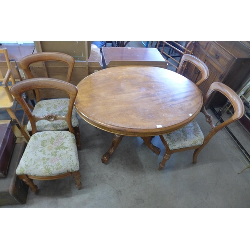 242 - A Victorian walnut oval tilt-top breakfast table and a set of four mahogany balloon back chairs