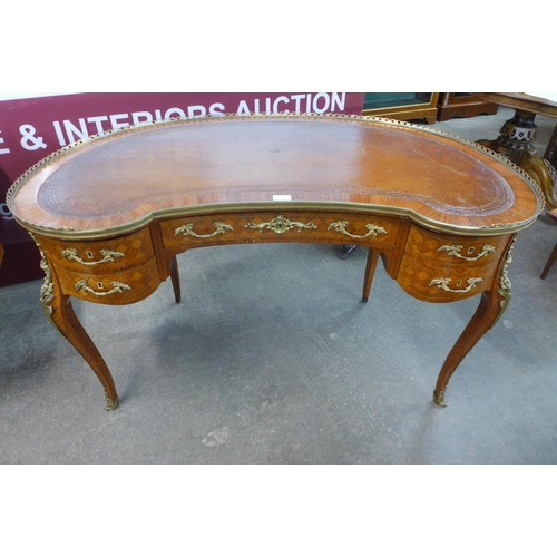 30 - A French Louis XV style parquetry inlaid kingwood and ormolu mounted kidney shaped writing table