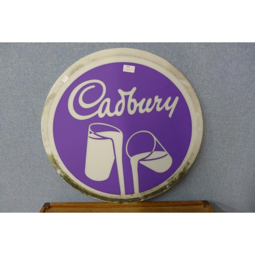 315 - A circular Perspex Cadbury advertising sign