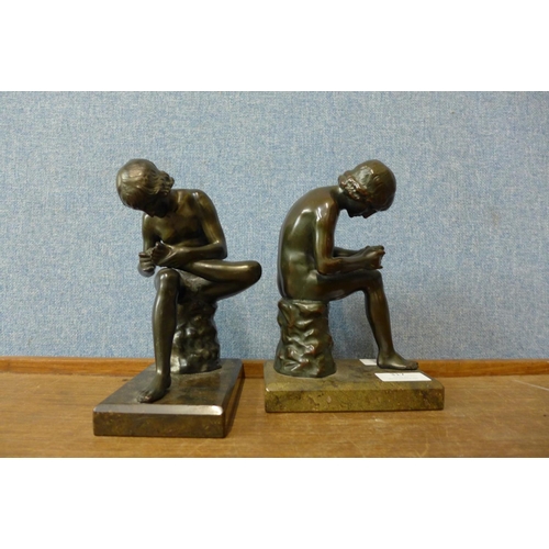 317 - Two French style bronze figures of boys with thorn in foot, on grey marble socles