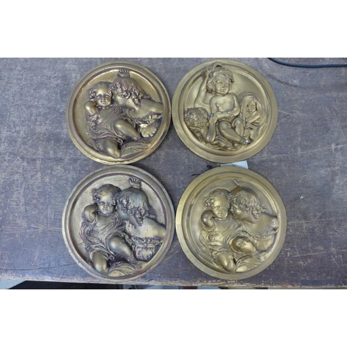 340 - A set of four gilt cherub plaques