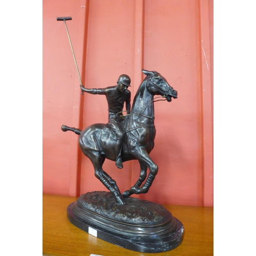 37 - A large bronze figure of a polo player on horse, on black marble plinth