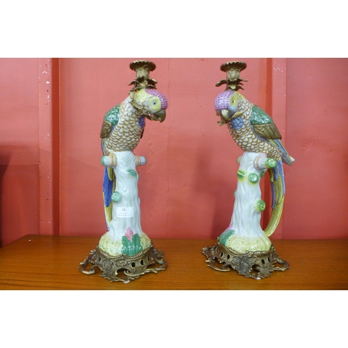 38 - A pair of French style porcelain and ormolu figural parrot candlesticks