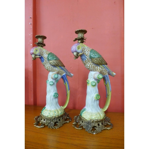 38 - A pair of French style porcelain and ormolu figural parrot candlesticks