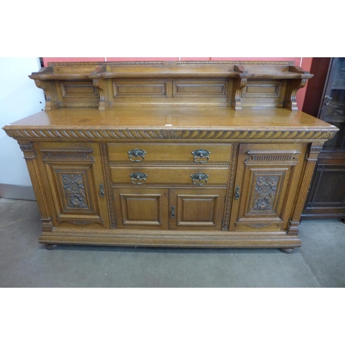 4 - A large Victorian carved oak sideboard