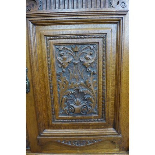 4 - A large Victorian carved oak sideboard