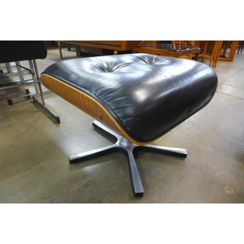 70 - A Charles & Ray Eames style black leather, rosewood effect and chrome footstool