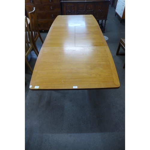 87 - A teak double leaf extending dining table