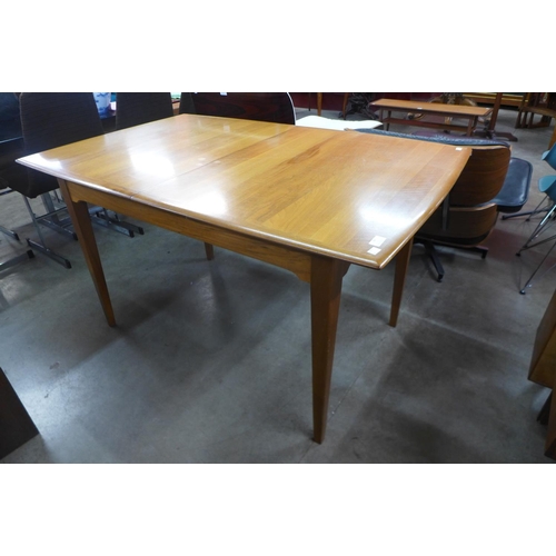 94 - A walnut extending dining table