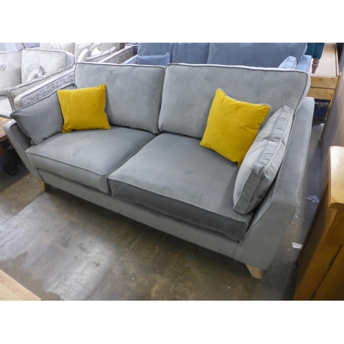 1582 - A grey velvet three seater sofa