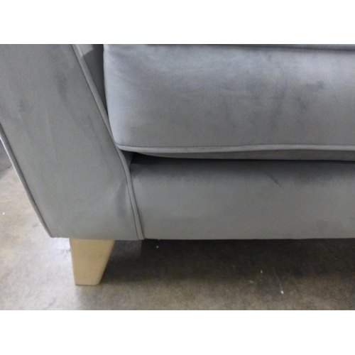 1582 - A grey velvet three seater sofa