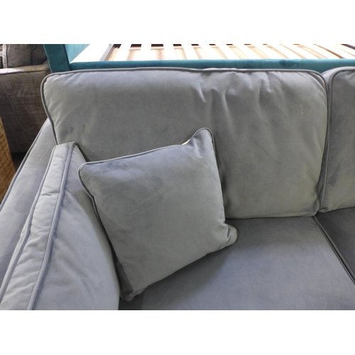 1583 - A steel blue velvet three seater sofa