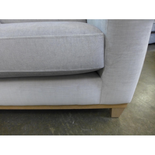 1590 - A taupe upholstered two seater sofa on a timber frame