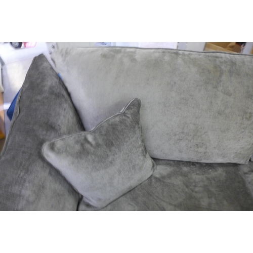 1600 - A pewter upholstered three seater sofa