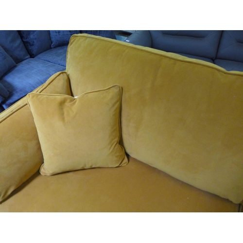 1609 - A turmeric velvet four seater sofa