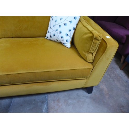 1609 - A turmeric velvet four seater sofa