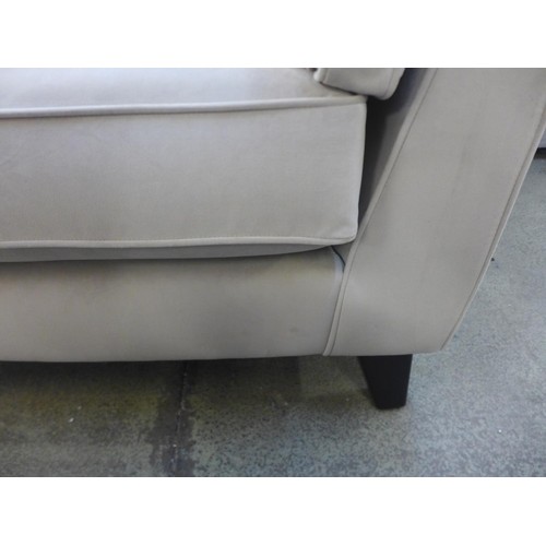 1696 - A taupe velvet two seater sofa