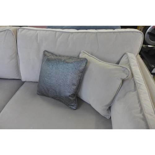 1697 - A taupe velvet four seater sofa