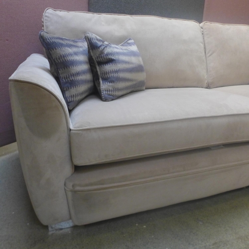 1694 - A taupe velvet four seater sofa - marks on back