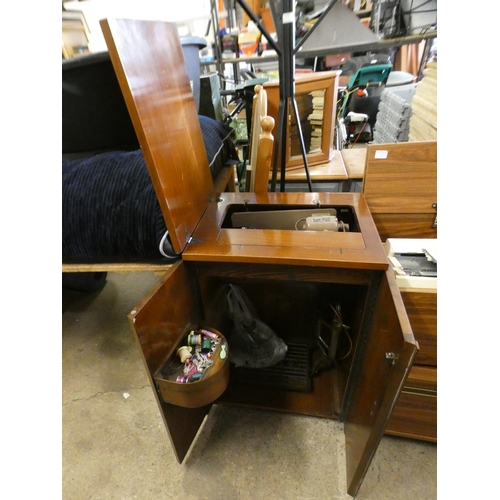 2296 - Singer electric sewing machine in work bench cabinet