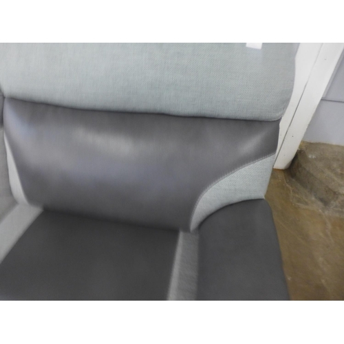 1535 - A black and grey upholstered electric reclining three seater sofa - damage, tear on the back of the ... 