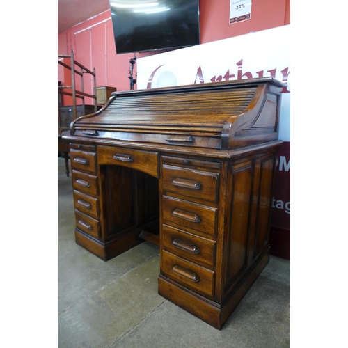 13 - An oak tambour roll top desk