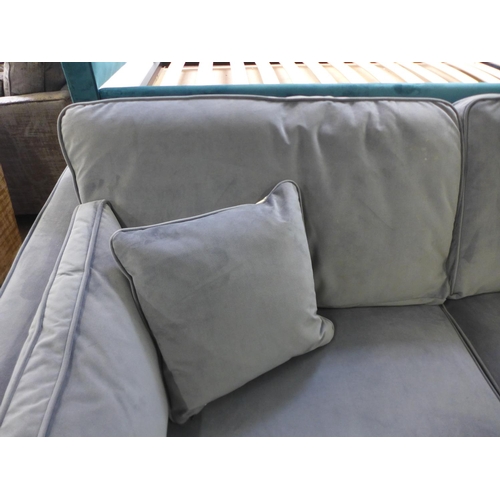 1556 - A steel blue velvet three seater sofa