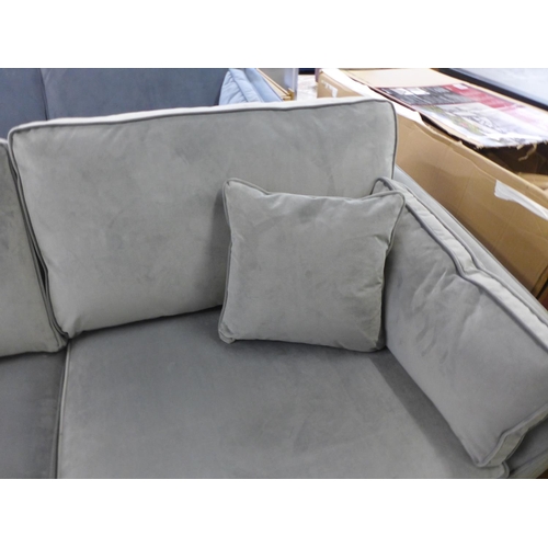 1557 - A grey velvet three seater sofa