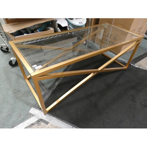 3323 - Gold effect metal x-frame glass topped coffee table (43.5cm H x 116.5cm W x 51cm D) * This lot is su... 