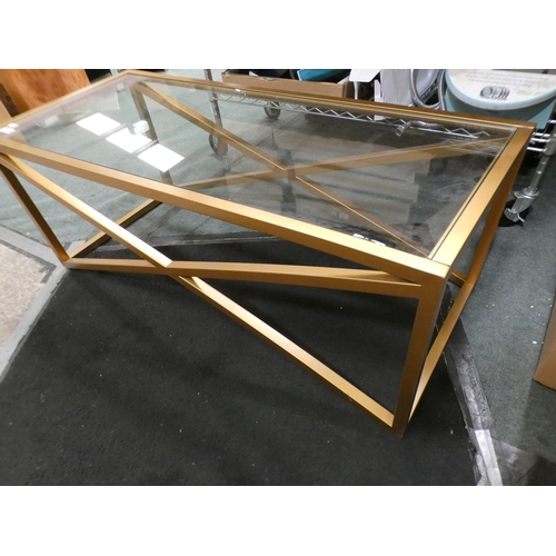 3323 - Gold effect metal x-frame glass topped coffee table (43.5cm H x 116.5cm W x 51cm D) * This lot is su... 