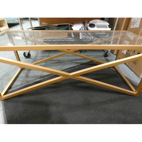 3323 - Gold effect metal x-frame glass topped coffee table (43.5cm H x 116.5cm W x 51cm D) * This lot is su... 