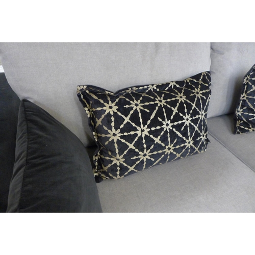 1402 - A black and taupe velvet three seater sofa on a timber frame