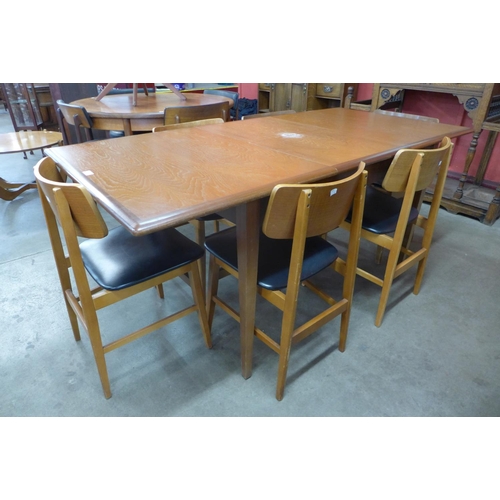 97 - A teak extending dining table and six chairs