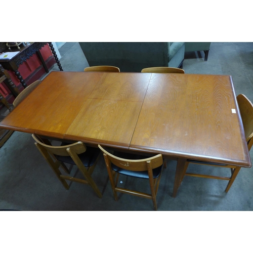 97 - A teak extending dining table and six chairs