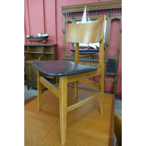 97 - A teak extending dining table and six chairs