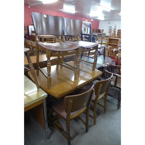 169 - A Beautility oak seven piece dining suite