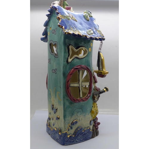 607 - A Heather Goldmine art pottery house, 30cm