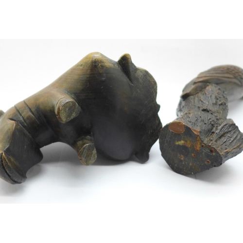 664 - A carved wooden hippopotamus and a resin hawk